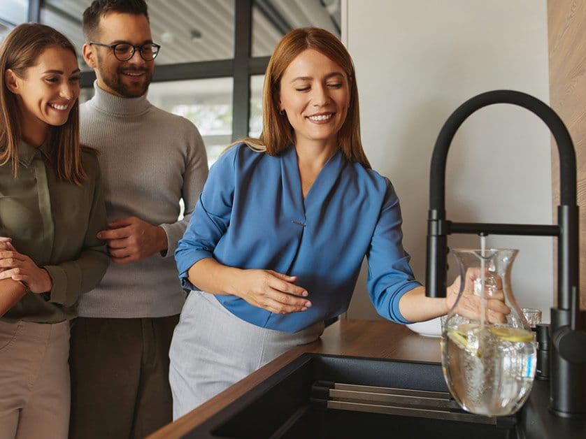 Woman Filling Water at Sink