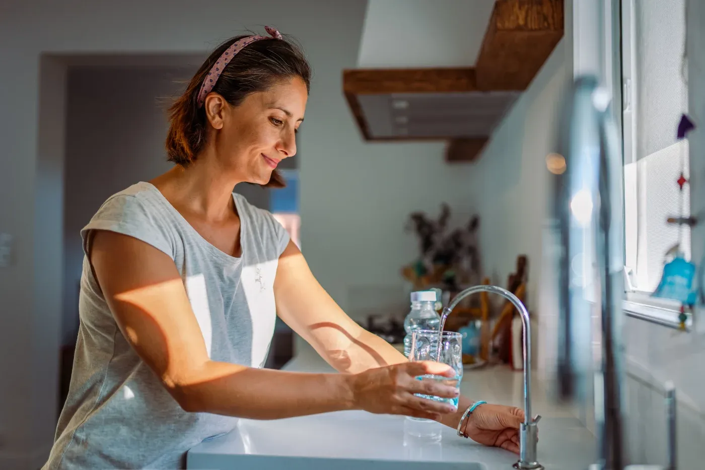 Woman Filling Water at Sink